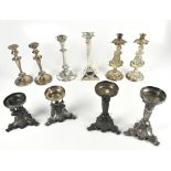 A group of silver plated candlesticks to include a pair of cast stem examples decorated with an