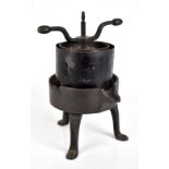 An unusual French iron and elm fruit press raised on out swept supports, height 47cm.Additional