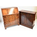 A reproduction mahogany bureau with fall front above four graduated drawers, width 75cm, and a