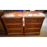 A pair of reproduction yew wood three drawer bedside chests, each height 64cm, width 48cm, depth