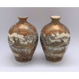 A pair of miniature Japanese Meiji period Satsuma vases decorated with continuous landscapes, both