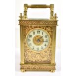 A 19th century French brass carriage clock with applied floral detail, circular dial with Arabic