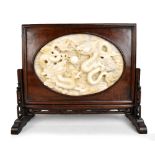 A large and impressive Chinese carved jade table screen, the central oval white jade panel depicting