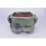 CHARLES BOUND (born 1939); an early stoneware twin handled vessel covered in metallic green glaze,