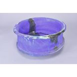 ASHLEY HOWARD (born 1963); a large stoneware bowl covered barium blue and purple glaze, impressed AH