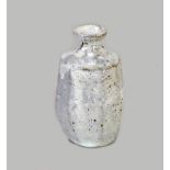 AKIKO HIRAI (born 1970); a small faceted stoneware bottle covered in grey glaze, height 12.5cm.