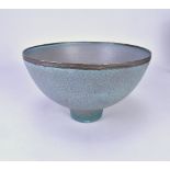 ABDO NAGI (1941-2001); a stoneware pedestal bowl covered in mottled blue glaze with bronze rim, made