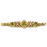 An Edwardian 15ct yellow gold peridot and seed pearl bracelet, the bracelet set with three square