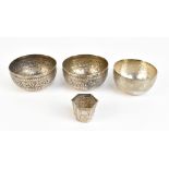 A pair of Eastern white metal bowls with repousse foliate scroll decoration, diameter 10.6cm, a