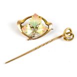 A 9ct yellow gold enamel and seed pearl brooch of open form with leaf decorated central panel (