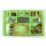 A quantity of assorted costume jewellery including various brooches, beads, etc.Additional