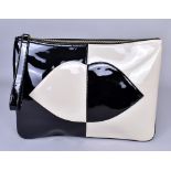 LULU GUINNESS; a patent leather cream and black clutch bag with hand strap with iconic lips