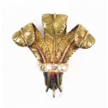 A yellow metal brooch in the form of The Prince of Wales' feathers, mounted with four melee