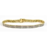 An 18ct yellow gold and diamond set line bracelet with panels of twelve tiny diamonds interspaced by