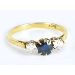 An 18ct yellow gold sapphire and diamond three stone ring, the sapphire weighing approx 0.7ct