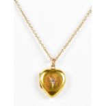 A 15ct yellow gold love heart pendant locket, mounted on yellow metal chain stamped 9ct, the