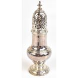 A white metal sugar caster with pierced domed lid and spreading circular foot, height 18.5cm.