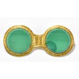 A yellow metal and malachite brooch of twin conjoined discs, unmarked, length 46mm.Additional