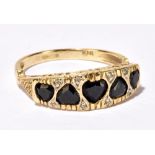 A 9ct yellow gold garnet and diamond chip ring, the graduated garnets of heart shape interspersed