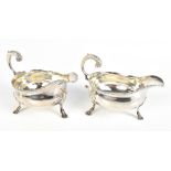 GEORGE SMITH; a pair of George III hallmarked silver sauce boats with beaded rims, high scrolling