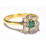 An 18ct yellow gold diamond and emerald cluster ring, size M/N, approx 3.7g.Additional