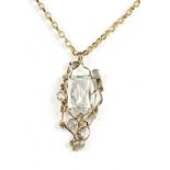 A yellow metal chain supporting an openwork pendant set with pale blue stones, chain stamped 9K,