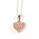 A natural pink diamond set rose gold heart shaped pendant suspended on a fine link chain, length