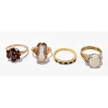 Four 9ct yellow gold dress rings comprising an opal example, size N, a smoky quartz example, size K,