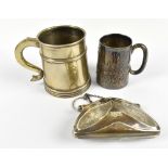 An Edward VII hallmarked silver christening cup with embossed decoration and vacant cartouche,