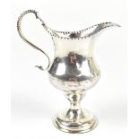 CHARLES HOUGHAM; a George III hallmarked silver cream jug with pinched spout, scroll handle and