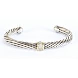 DAVID YURMAN; a silver, 18ct yellow gold and diamond set torque bracelet, external width 7.8cm,