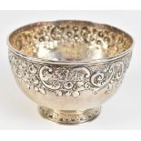 A George III hallmarked silver bowl with floral embossed border on spreading circular foot, London