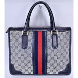 GUCCI; a GG monogram canvas and navy blue leather Boston style handbag, 32 x 25 x 15cm.Additional