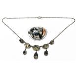 A white metal Arts & Crafts moss agate set necklace with five graduated oval cabochons suspending