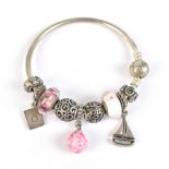 PANDORA; a charm bracelet set with several charms, including one in the form of a sailing boat,