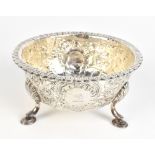An 18th century Irish silver sugar bowl with later profuse decoration featuring an Oriental