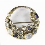 ATTRIBUTED TO DORRIE NOSSITER; a silver and gem set Arts & Crafts brooch set with moonstone,