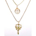 An Edwardian Art Nouveau 9ct yellow gold green peridot and cultured pearl pendant suspended on a 9ct