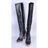 PRADA; a pair of black embossed leather knee-high boots, heel 12cm (size 38.5).Additional