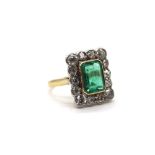 An 18ct yellow gold Art Deco style emerald and diamond ring, the central emerald weighing approx 2.