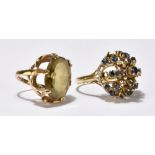 A yellow metal and sapphire open work domed coronet cluster ring with further scrolled detail,