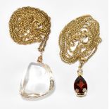 A yellow metal garnet and diamond pendant, marked 375, suspended from a yellow metal chain,