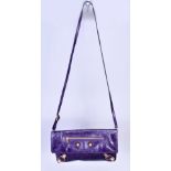 BALENCIAGA; a purple leather envelope bag with cross body strap and rose gold tone hardware.