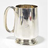 BARKER BROTHERS; a George V hallmarked silver mug raised on stepped base, Chester 1926, approx 11.