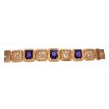 An unusual Egyptian Revival yellow metal and alexandrite bracelet set with three rectangular cut