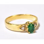 A yellow metal diamond and emerald ring, the inner band stamped 750, size I, approx 2.8g, sold