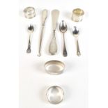 A group of variously hallmarked silver items comprising three teaspoons, four single napkin rings