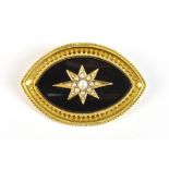 A Victorian yellow metal mourning brooch with central black enamelled panel set with a star of