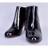 CHRISTIAN LOUBOUTIN; a pair of 'Belle 85' patent soft leather booties with zip side closures, unworn