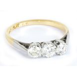 An 18ct yellow gold and diamond three stone graduated diamond ring, the central stone weighing